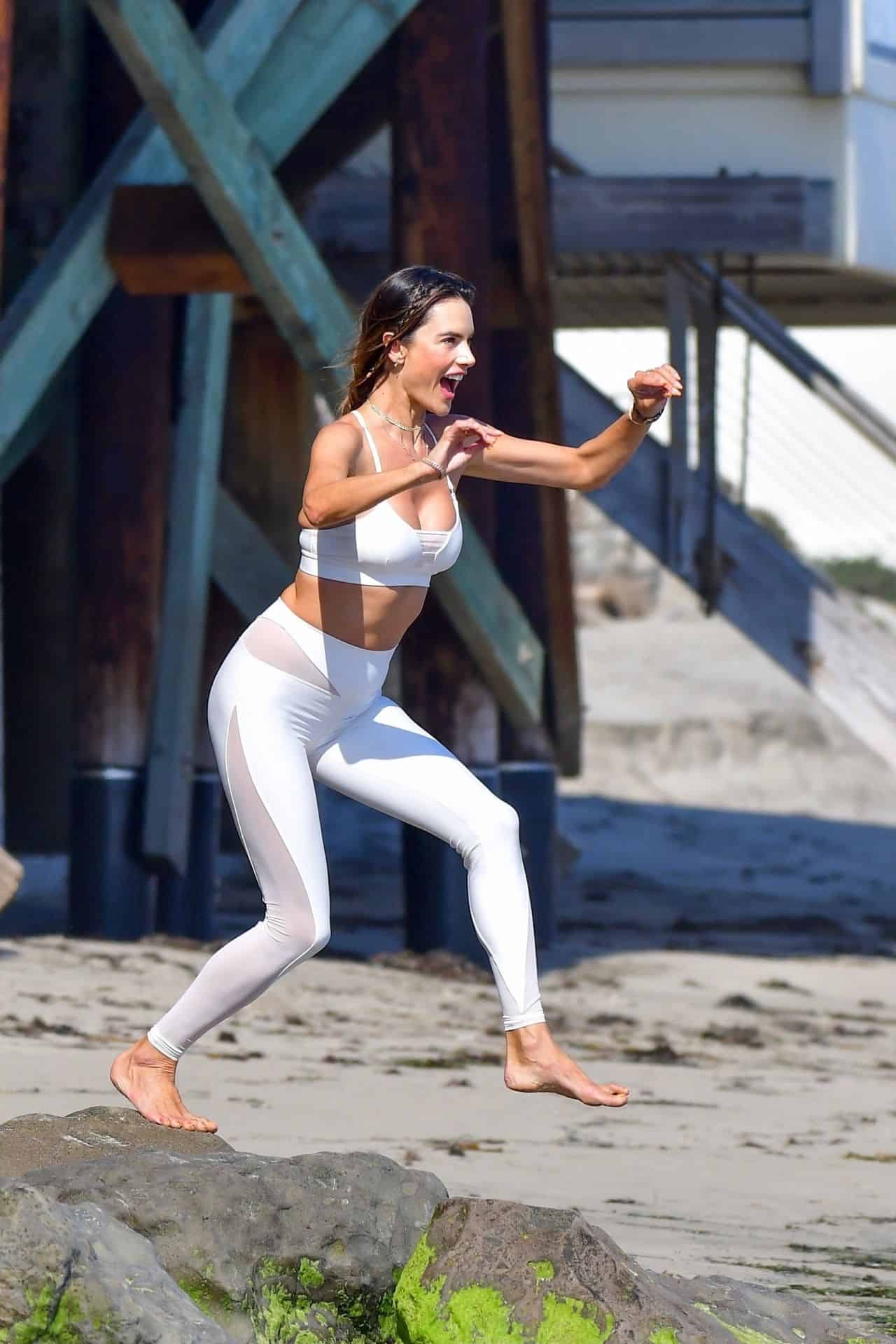 Alessandra Ambrosio in a White Workout Outfit Posing for a Beach Photoshoot