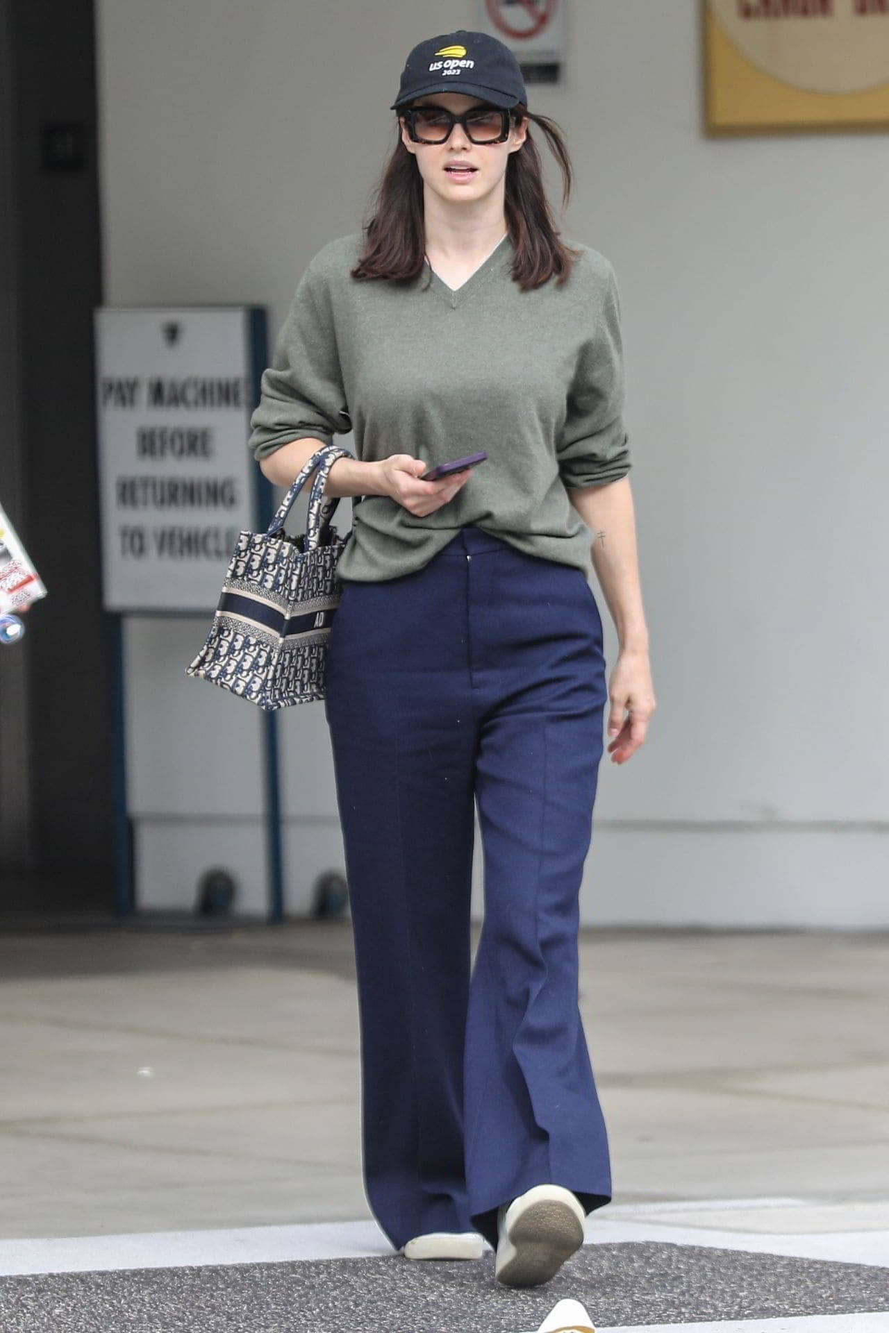 Alexandra Daddario Exudes Casual Chic in an Olive Sweater and Navy Pants - 1